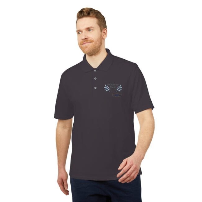 Man wearing a dark polo with a small embroidered blue laurel wreath on the left chest against a white background.