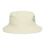 Cream bucket hat with stitched brim and blue-green leaf embroidery on the side, close-up view.