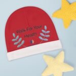Red round booklet with the words 'Walk For Your Health' and blue leaf motifs on a light blue background, with a yellow knitted star shape nearby.