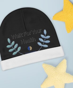 Black circular fabric with blue embroidered leaves and the phrase 'Walk For Your Health' on a pale blue background, with a yellow knitted star in the top-right corner.