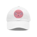 White cap with a pink circular patch on the front reading 'Walk For Your Health' and decorative leaves.