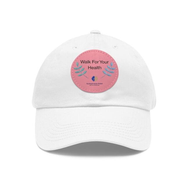 White cap with a pink circular patch on the front reading 'Walk For Your Health' and decorative leaves.