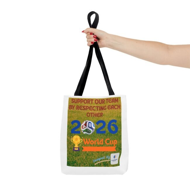 Hand gripping black tote bag straps, showing a poster that reads 'Support Our Team by Respecting Each Other' for World Cup 2026 on the bag.