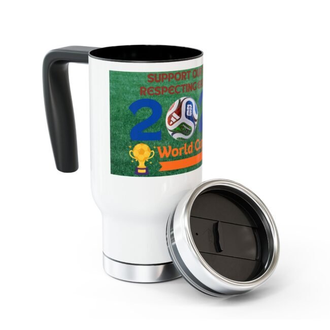 White ceramic travel mug with a green World Cup label, soccer ball image, and trophy on grass; lid removed and resting nearby.