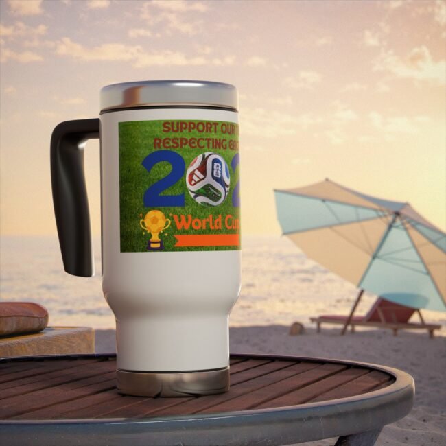 Close-up of a white mug with a glossy lid on a wooden table at the beach, featuring a colorful World Cup sticker with soccer imagery in the foreground.