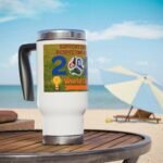 White mug on a wooden table at the beach with a colorful World Cup sticker featuring a soccer ball and trophy image