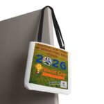 White tote bag hanging on a grey panel, featuring a colorful poster with soccer graphics and the words World Cup.