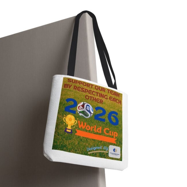 White tote bag hanging on a grey panel, featuring a colorful poster with soccer graphics and the words World Cup.