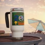 Close-up of a white mug with a colorful poster about the World Cup, placed on a wooden table at the beach with umbrellas in the background.
