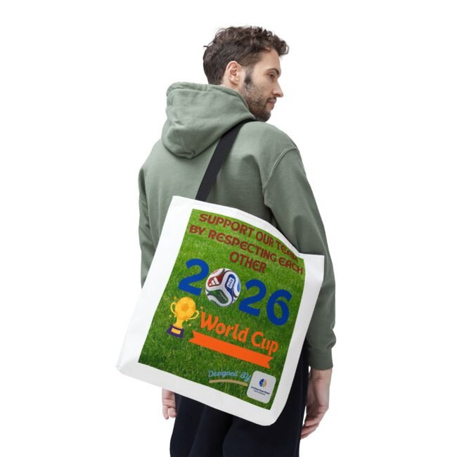 Side-view of a man in a green hoodie carrying a white tote bag with a colorful World Cup poster featuring soccer balls.