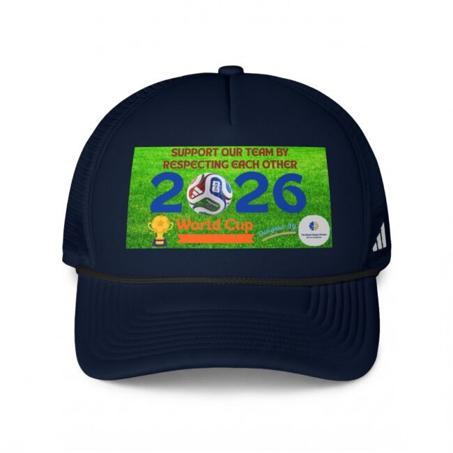 Close-up of a navy baseball cap with a bright green sticker on the front, showing part of the text and designs behind a curved brim.