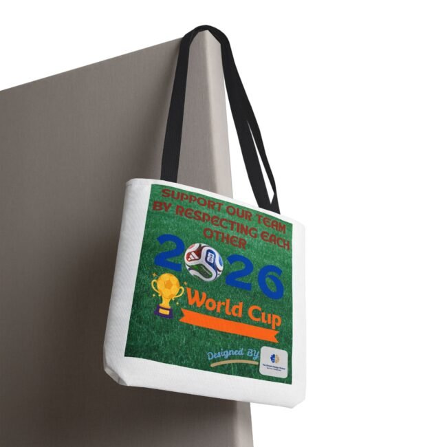 Gray reusable tote bag with black straps hanging from a corner, showing a green poster that reads 'World Cup 2026' with soccer imagery and a trophy