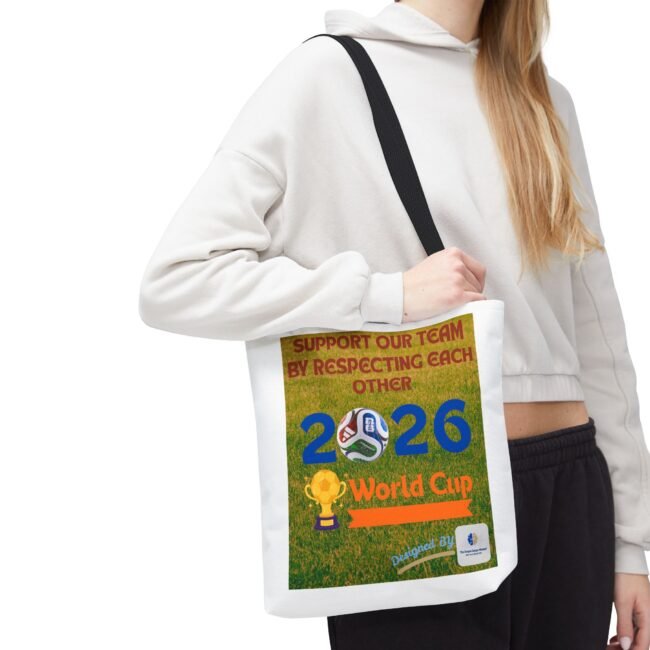 Person wearing a white hoodie with a black shoulder strap carrying a bag with a bright poster that says "World Cup 2026"