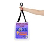 Hand gripping black bag straps with a purple poster that says 'Support Our Team by Respecting Each Other' on a white tote bag (World Cup theme)