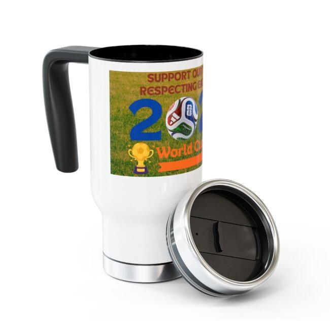 White ceramic mug with a colorful World Cup poster wraparound showing soccer imagery and a trophy, black interior visible at top edge and a detachable lid nearby.