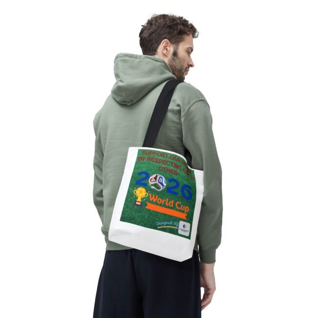 Man in a green hoodie carries a white tote bag over his shoulder, viewed in profile from the back.