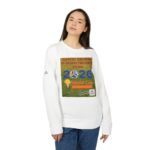 Person wearing a white sweatshirt with a large colorful graphic on the chest, standing against a white background, looking slightly to the side.