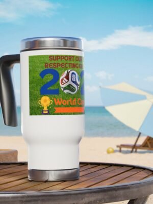 8606363565256162115_2048jpeg | the Mindset Designed White Travel Mug on a Wooden Table at the Beach, Featuring a World Cup Graphic and Soccer Ball Motif on a Green Label.
