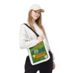 Young woman wearing a white hoodie and cap, with a large green race bib slung over her chest.