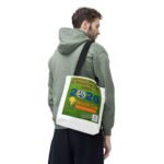 Side profile of a man in a green hoodie, carrying a white tote bag with a 2026 World Cup poster graphic.